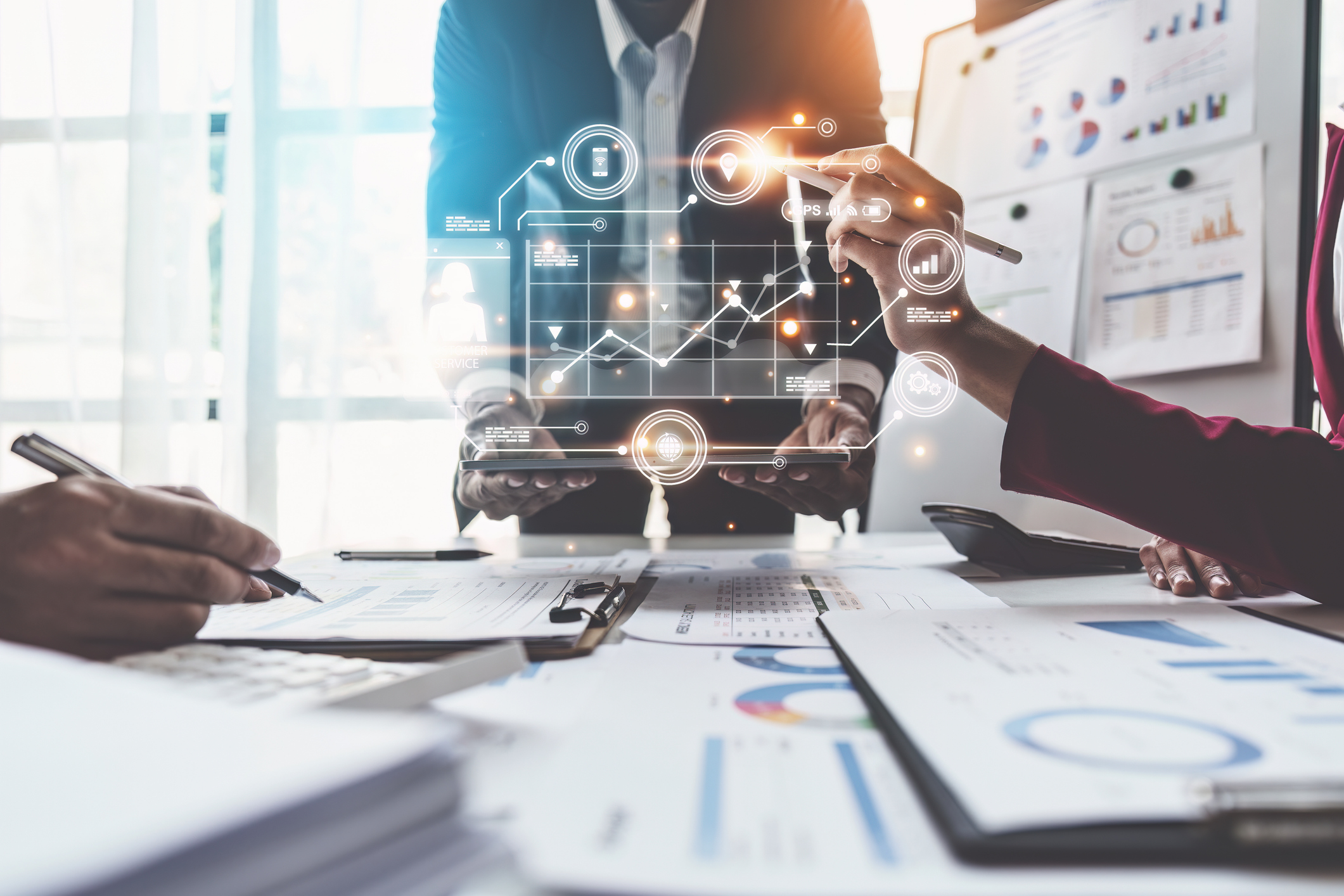 Charts and graphs displayed over people working